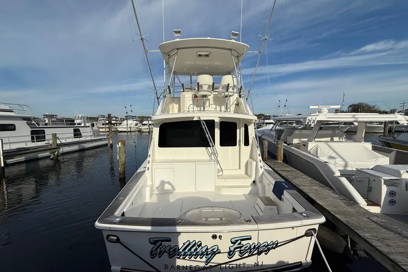 Slide: The Image of 2005 Ocean Yachts 46 Super Sport docked at marina under clear sky. - 5