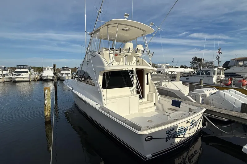 Slide: The Image of 2005 Ocean Yachts 46 Super Sport docked at marina under clear sky. - 6