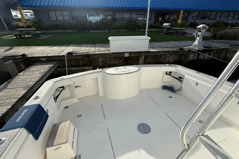 Slide: The Image of 2005 Ocean Yachts 46 Super Sport boat deck at marina, featuring spacious seating and storage. - 7
