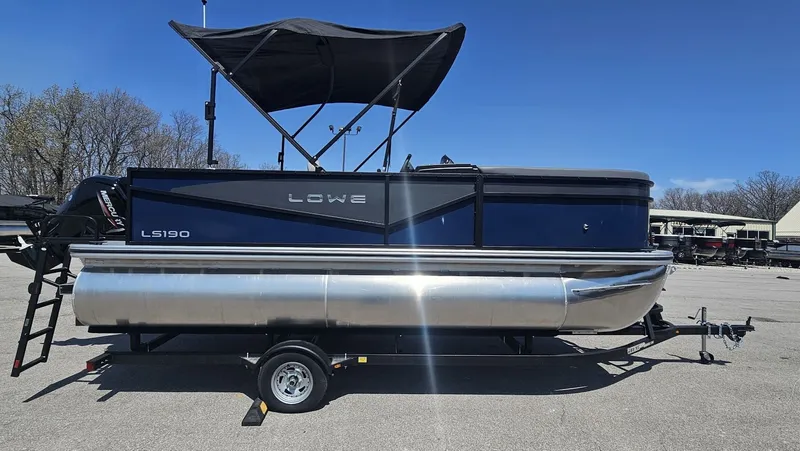 Slide: The Image of Lowe LS 190 pontoon boat 2025 on trailer, blue sky. - 19