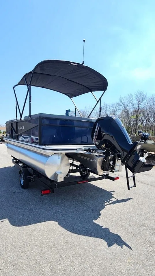 Slide: The Image of 2025 Lowe LS 190 pontoon boat with outboard motor and canopy. - 4