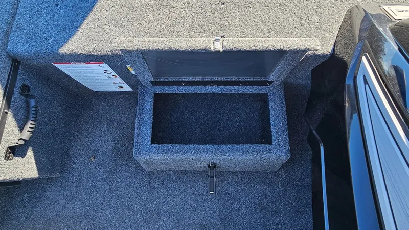 Slide: The Image of Lowe Stinger 175C 2026 boat compartment with carpeted interior. - 22