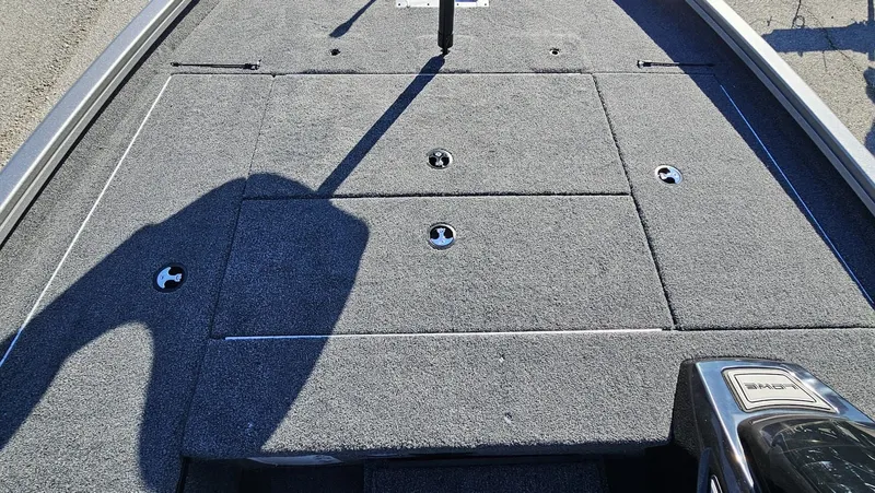 Slide: The Image of Lowe Stinger 175C 2026 boat deck with gray carpet flooring. - 23