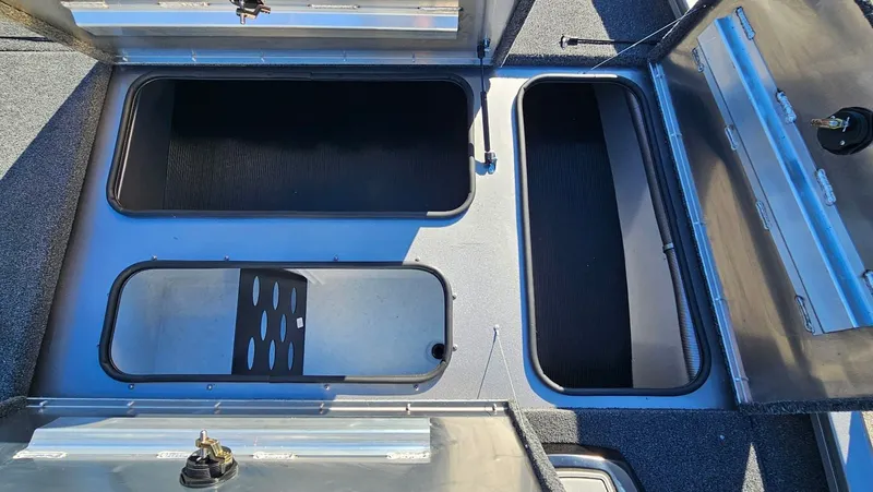 Slide: The Image of Lowe Stinger 175C 2026 boat storage compartments open. - 27