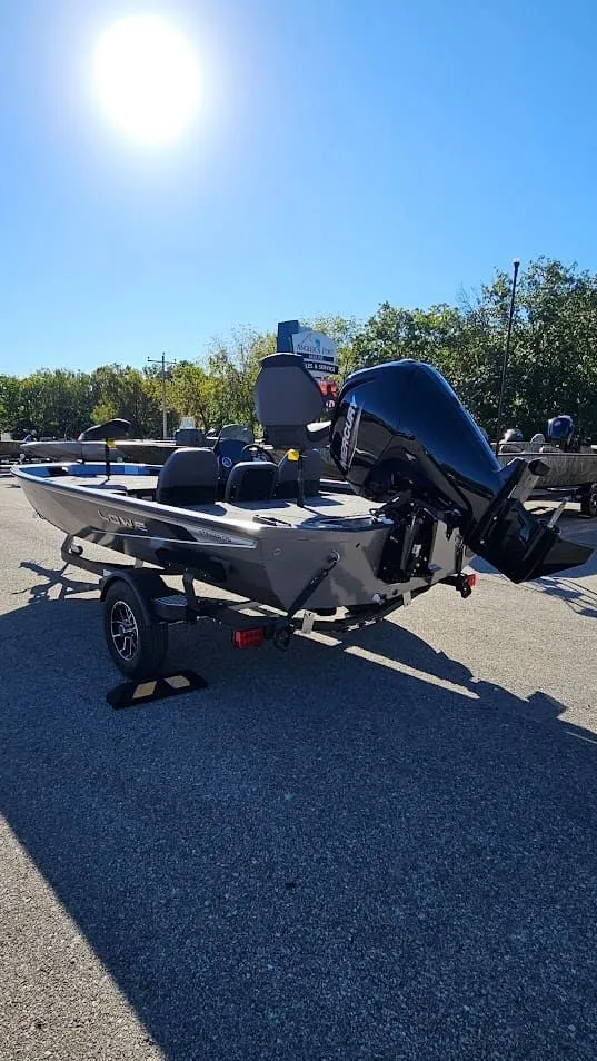 Slide: The Image of 2026 Lowe Stinger 175C boat on trailer under bright sun. - 5