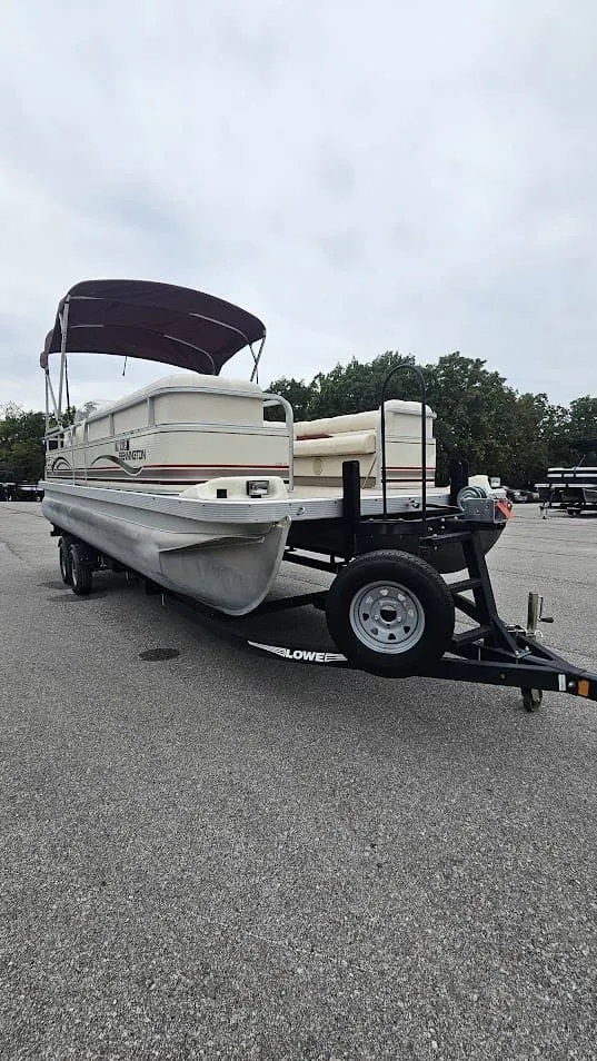 Slide: The Image of 2000 Bennington 2050LX pontoon boat on trailer outdoors. - 11