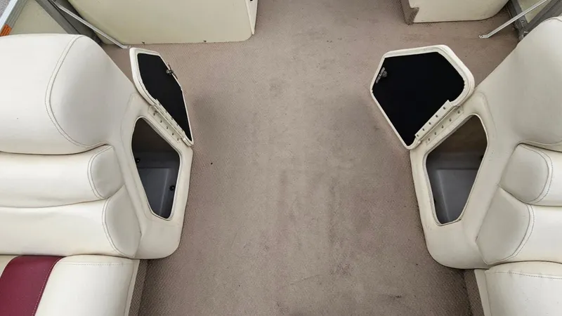 Slide: The Image of Interior of a 2000 Bennington 2050LX boat with open storage compartments. - 22