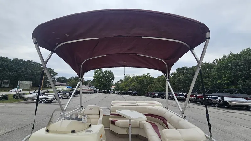 Slide: The Image of 2000 Bennington 2050LX pontoon boat with canopy and seating area. - 24