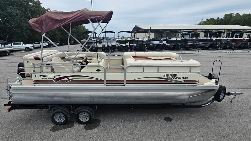 Slide: The Image of 2000 Bennington 2050LX pontoon boat parked on trailer. - 5