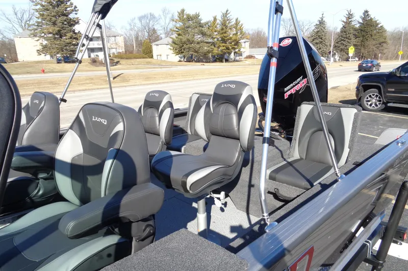 Slide: The Image of 2026 Lund 2075 Impact XS boat interior with seating and Mercury Pro XS engine. - 12