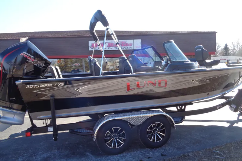 Slide: The Image of 2026 Lund 2075 Impact XS boat on trailer, featuring sleek design and powerful engine. - 15