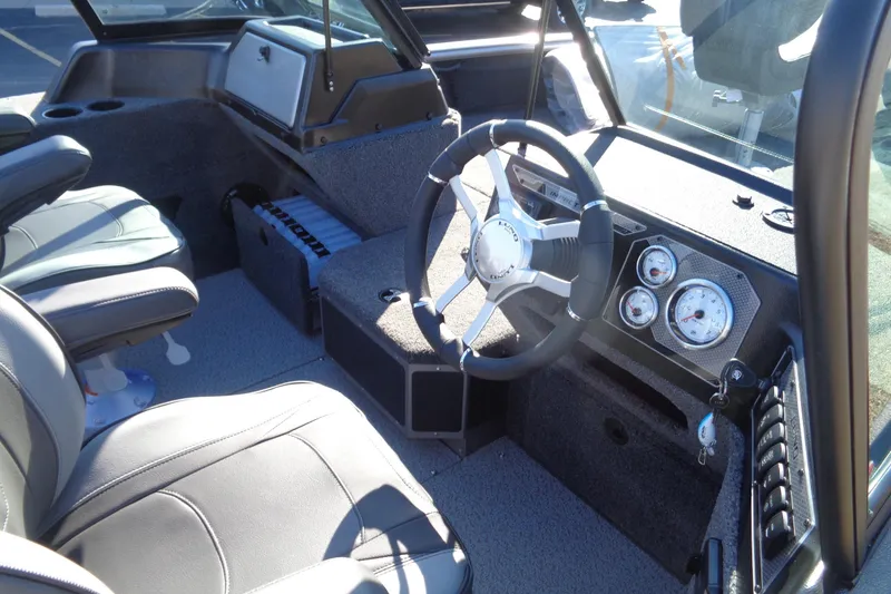Slide: The Image of Interior of 2026 Lund 2075 Impact XS boat with steering wheel and dashboard controls. - 17