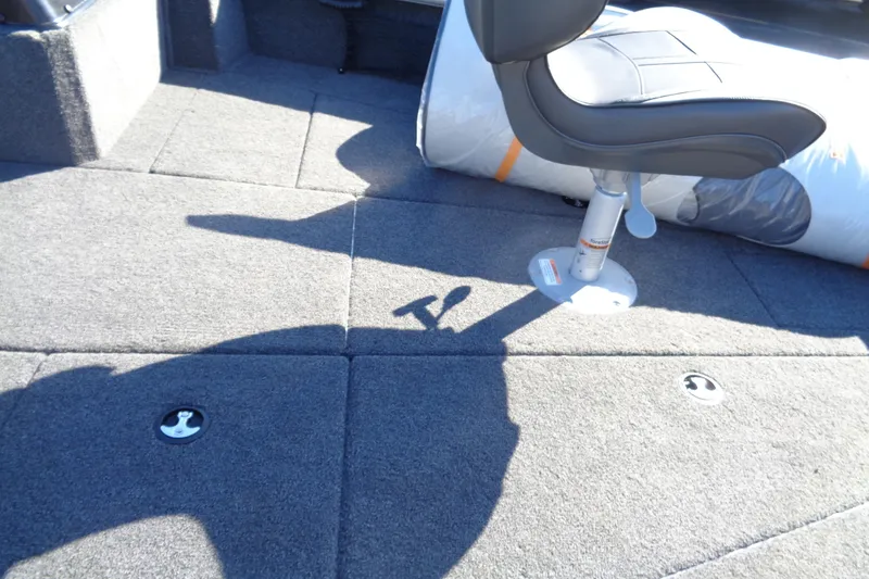 Slide: The Image of 2026 Lund 2075 Impact XS boat interior with gray carpet and adjustable seat. - 19