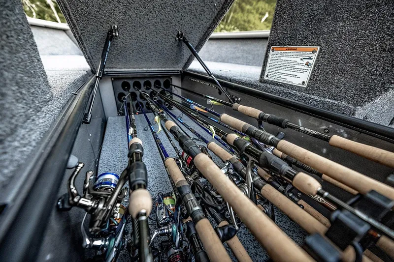 Slide: The Image of Manufacturer Provided Image: Manufacturer Provided Image: Fishing rods stored in a 2025 Lund 2025 Impact XS Sport boat compartment. - 28