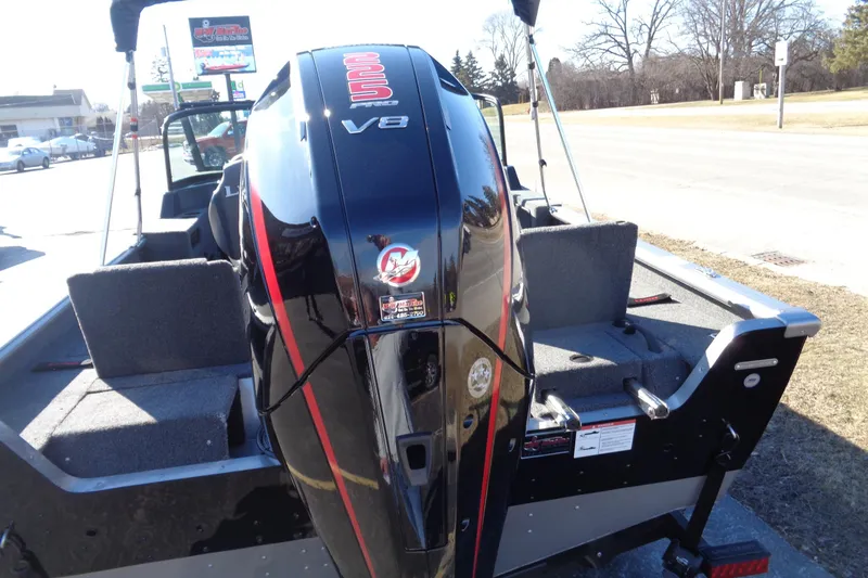 Slide: The Image of 2026 Lund 2075 Impact XS boat with powerful V8 engine, parked outdoors. - 4