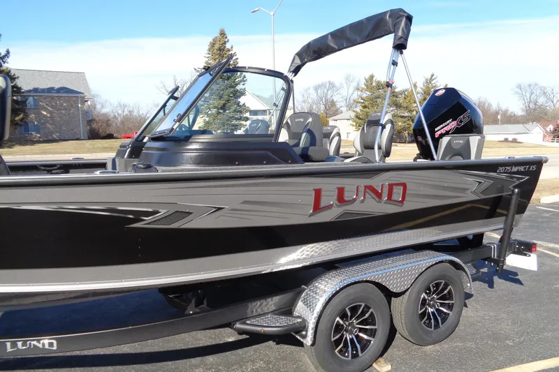 Slide: The Image of 2026 Lund 2075 Impact XS boat on trailer, featuring sleek design and modern features. - 5