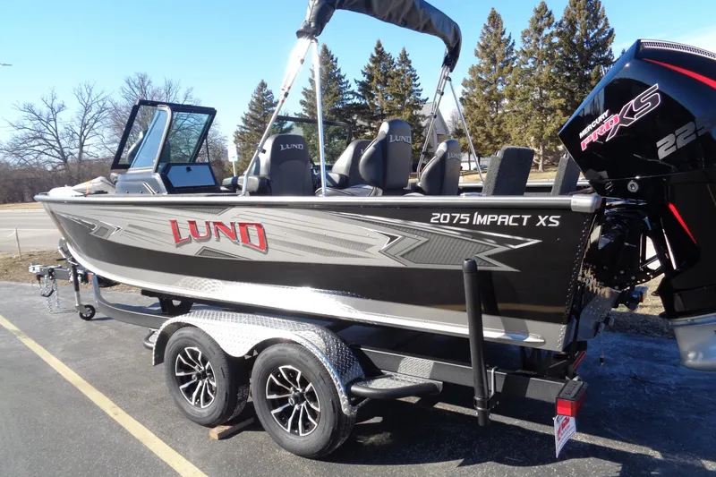 Slide: The Image of 2026 Lund 2075 Impact XS boat on trailer, featuring Mercury Pro XS engine. - 6