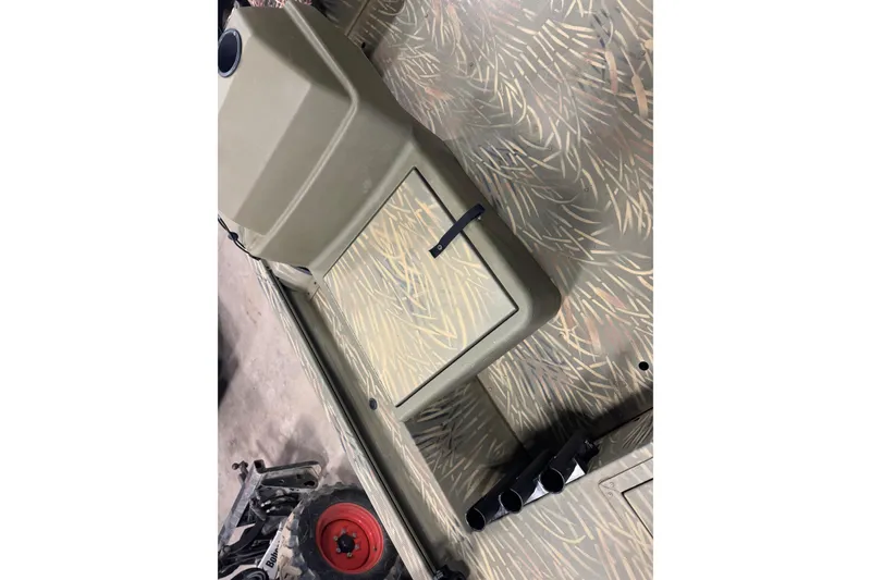 Slide: The Image of 2019 Tracker Grizzly 1754 MVX SC boat interior with camouflage pattern and storage compartment. - 11