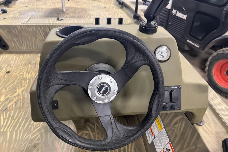 Slide: The Image of Steering console of 2019 Tracker Grizzly 1754 MVX SC boat with controls and gauge. - 15