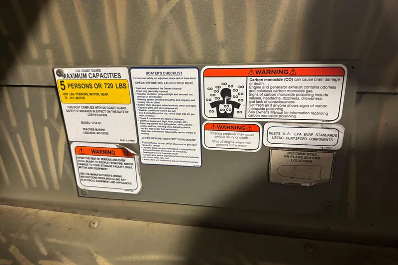 Slide: The Image of 2019 Tracker Grizzly 1754 MVX SC safety and capacity warning labels. - 16