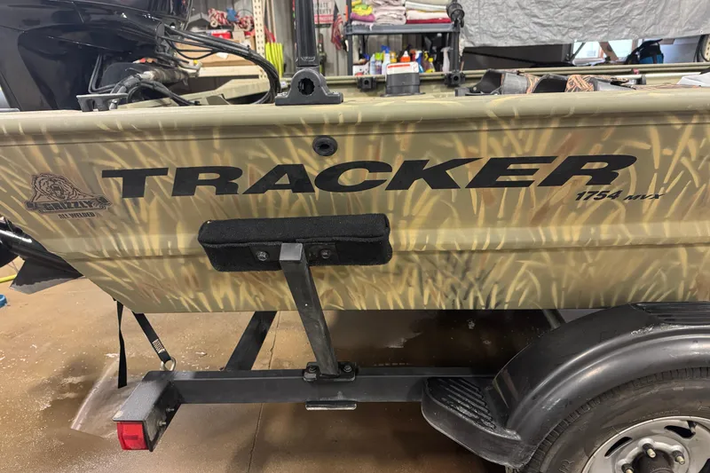 Slide: The Image of 2019 Tracker Grizzly 1754 MVX SC boat with camouflage design on trailer. - 19