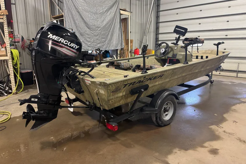 Slide: The Image of 2019 Tracker Grizzly 1754 MVX SC boat with Mercury engine in garage. - 3