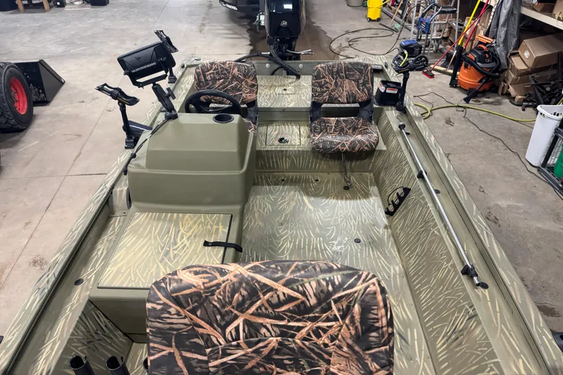 Slide: The Image of 2019 Tracker Grizzly 1754 MVX SC boat with camo seats and fishing equipment. - 7