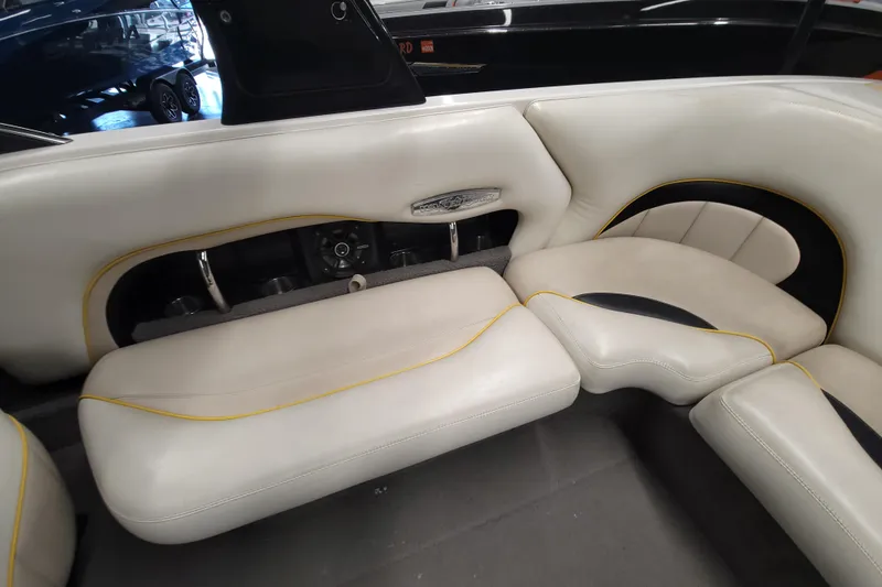 Slide: The Image of 2006 Malibu Wakesetter 23 LSV interior with white leather seating and yellow accents. - 12