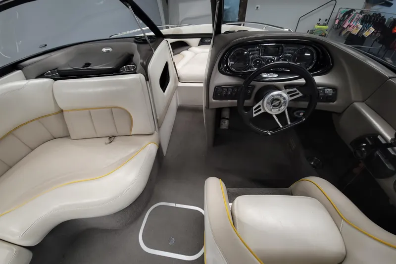 Slide: The Image of 2006 Malibu Wakesetter 23 LSV interior with beige seating and modern dashboard. - 13