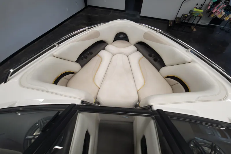 Slide: The Image of 2006 Malibu Wakesetter 23 LSV boat interior with white cushioned seating. - 14