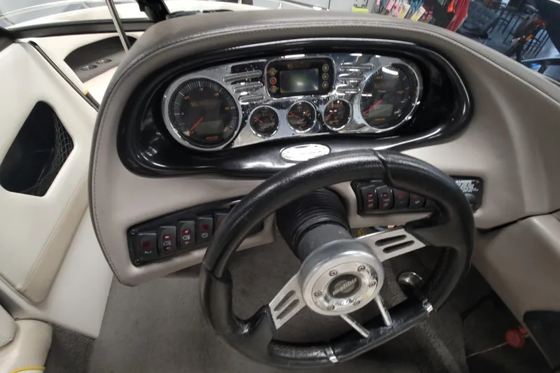 Slide: The Image of 2006 Malibu Wakesetter 23 LSV dashboard with steering wheel and instrument panel. - 15