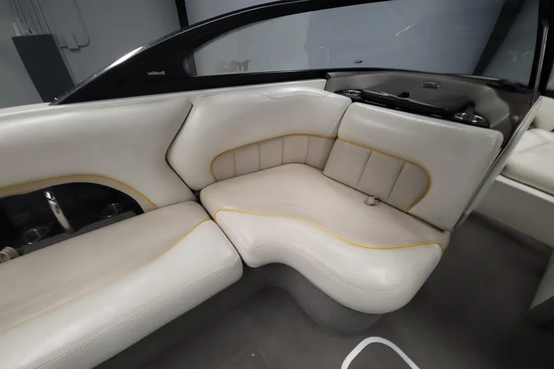 Slide: The Image of 2006 Malibu Wakesetter 23 LSV interior with white leather seating and yellow accents. - 9
