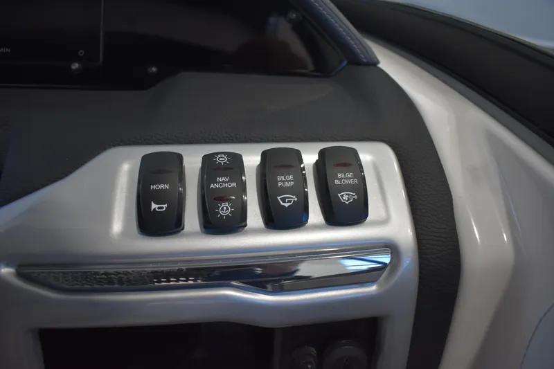 Slide: The Image of Control panel of a 2026 Regal 2000 ES boat with various switches. - 18