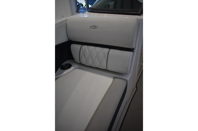 Slide: The Image of 2026 Regal 2000 ES boat interior with white cushioned seating and cup holder. - 23