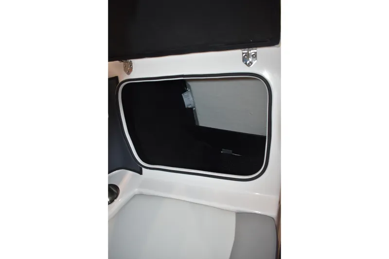 Slide: The Image of Interior view of 2026 Regal 2000 ES boat cabin with window and seating. - 24