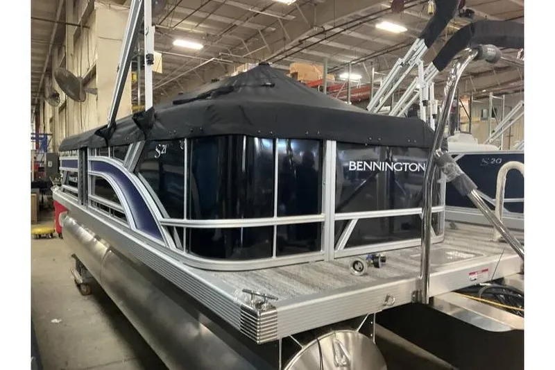 Slide: The Image of 2026 Bennington 21 SL pontoon boat with privacy curtain in warehouse. - 10