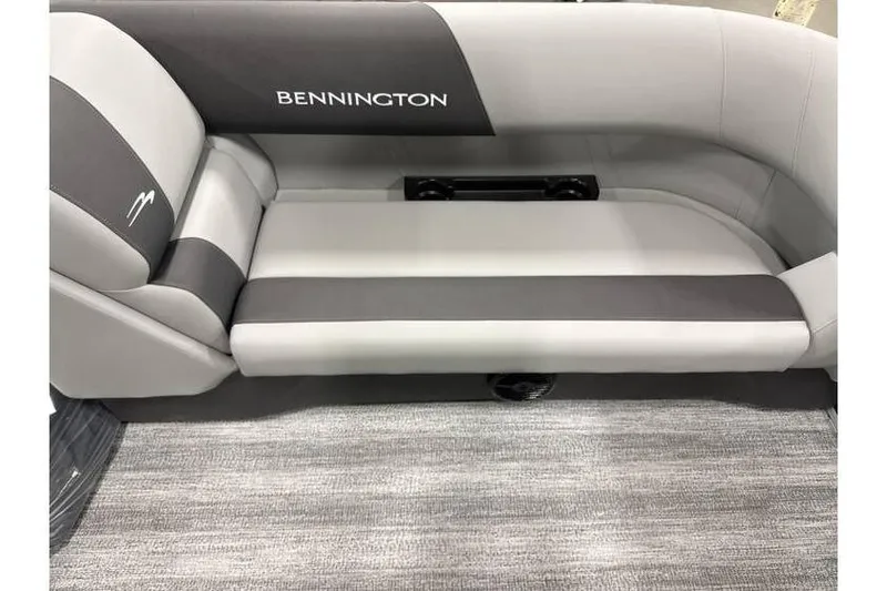 Slide: The Image of 2026 Bennington 21 SL boat interior with gray seating and privacy curtain. - 13