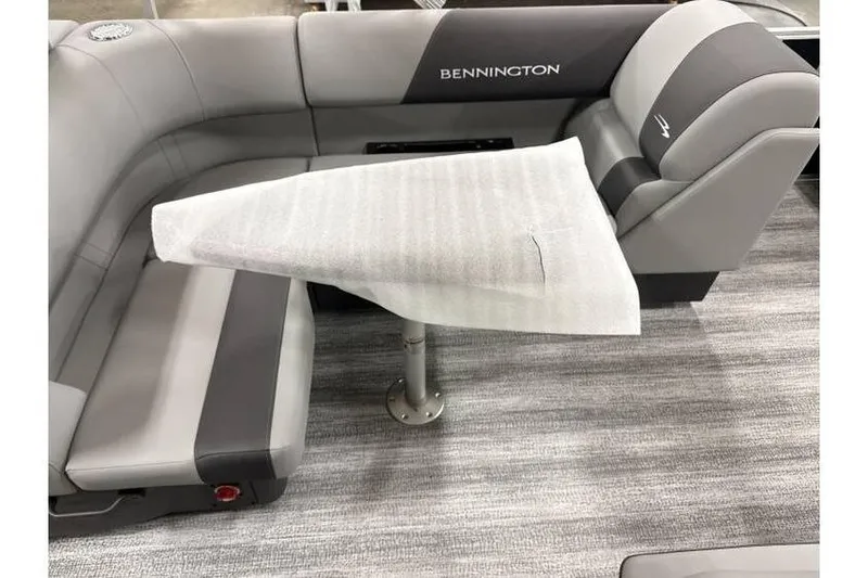 Slide: The Image of 2026 Bennington 21 SL boat interior with seating and table, featuring privacy curtain. - 15