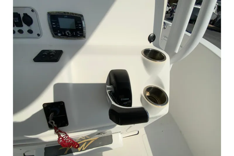 Slide: The Image of 2014 Tidewater 250 CC Adventure boat console with Yamaha controls and cup holders. - 12