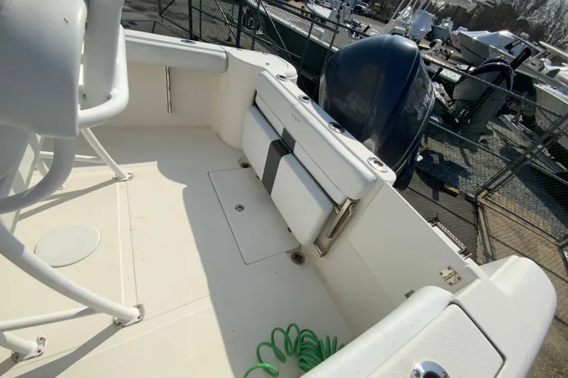Slide: The Image of 2014 Tidewater 250 CC Adventure boat deck with seating and engine view. - 13