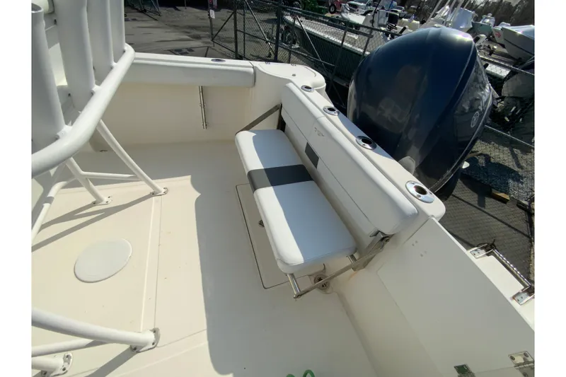 Slide: The Image of 2014 Tidewater 250 CC Adventure boat interior with seating and engine view. - 14