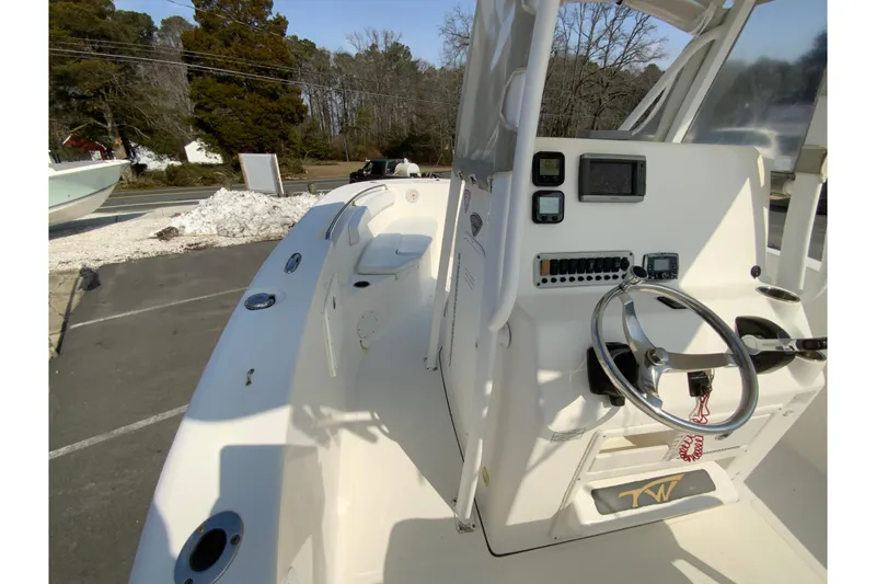 Slide: The Image of 2014 Tidewater 250 CC Adventure boat interior with steering console and controls. - 16