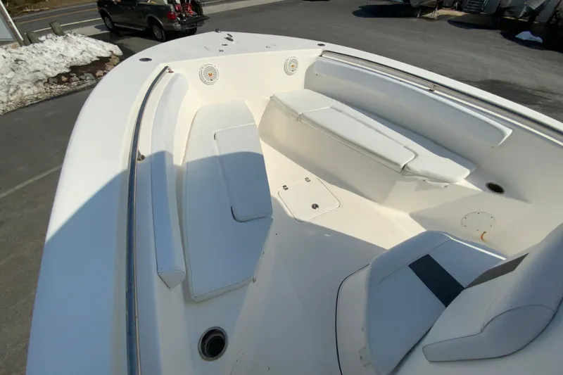 Slide: The Image of 2014 Tidewater 250 CC Adventure boat interior with white seating and spacious deck. - 17