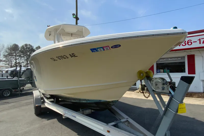 Slide: The Image of 2014 Tidewater 250 CC Adventure boat on trailer at dealership. - 2