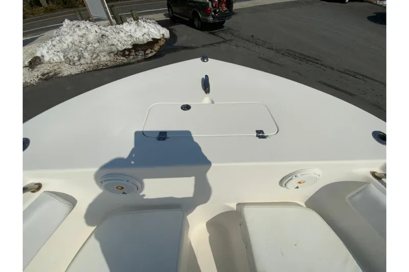 Slide: The Image of Bow of 2014 Tidewater 250 CC Adventure boat with seating and storage compartments. - 20