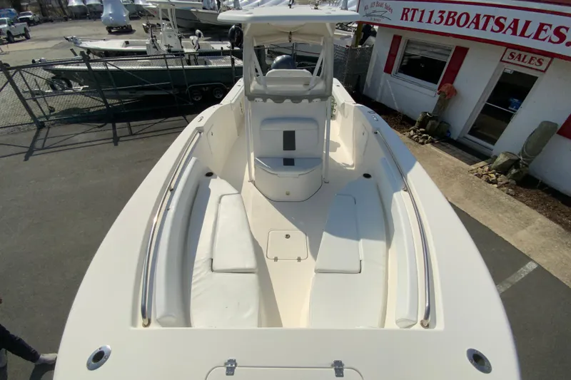 Slide: The Image of 2014 Tidewater 250 CC Adventure boat at dealership, showcasing spacious deck and seating. - 22