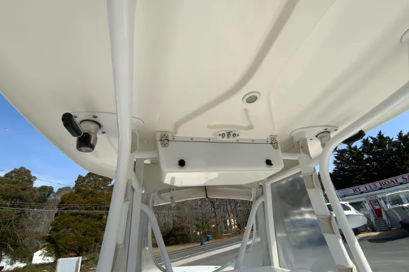Slide: The Image of 2014 Tidewater 250 CC Adventure boat interior view, showcasing overhead structure and equipment. - 29