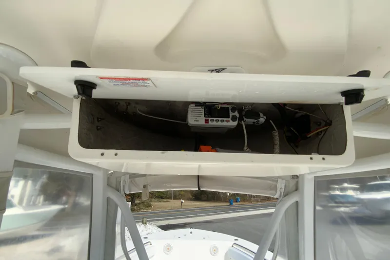 Slide: The Image of 2014 Tidewater 250 CC Adventure boat console storage with electronic equipment. - 31