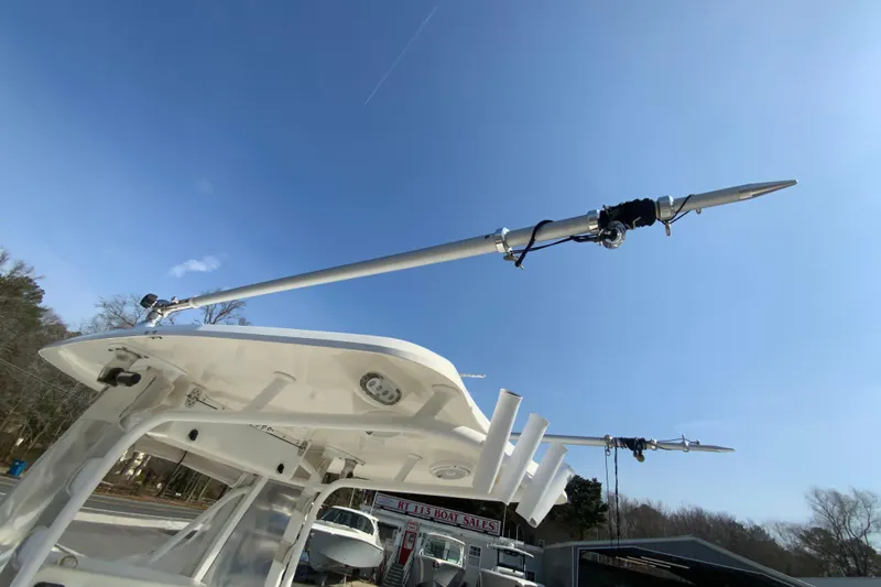 Slide: The Image of 2014 Tidewater 250 CC Adventure boat with outriggers under clear blue sky. - 32