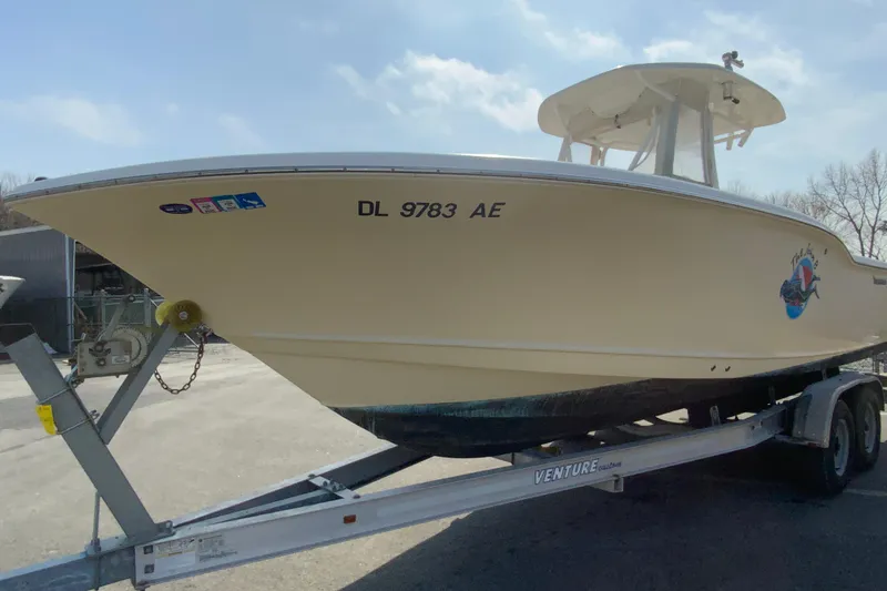 Slide: The Image of 2014 Tidewater 250 CC Adventure boat on trailer, side view, outdoors. - 4